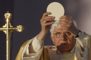 Pope Benedict XVI raises the Eucharist as he celebrates Mass at Bellahouston Park in Glasgow, Scotland, Sept. 16. The pope was on a four-day visit to Great Britain. (CNS photo/Phil Noble, Reuters) (Sept. 16, 2010) See BRITAIN-GLASGOW Sept. 16, 2010.